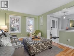 Entryway featuring a white paneled door with decorative glass inserts, ceramic tile flooring, and a contemporary pendant light fixture - 