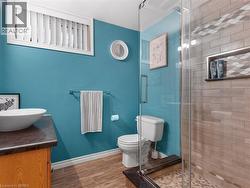 Glass-enclosed shower with a tiled surround featuring a decorative accent and built-in niche - 