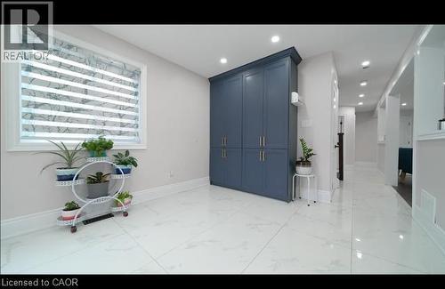Recessed lighting, light-toned walls, white window trim, and white floor tiling - 643 Doon South Drive, Kitchener, ON 