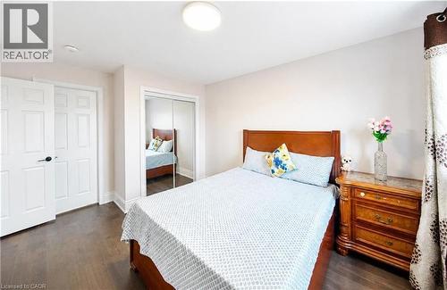 Dark wood-finish flooring with light-toned walls - 643 Doon South Drive, Kitchener, ON 