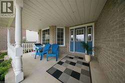 Covered front porch featuring brick exterior - 