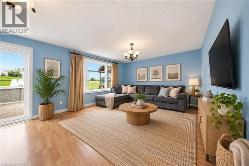 Light wood-finish flooring, recessed lighting, and a glass-paneled patio door - 61 Sunnyside Drive, St. George, ON 