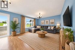 Light wood-finish flooring, recessed lighting, and a glass-paneled patio door - 