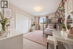 Dual bi-fold closet doors, wall-to-wall carpeting, and a built-in window with drapes - 