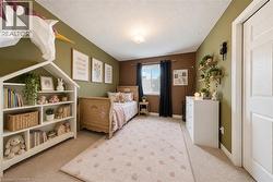 Built-in shelving unit with multiple compartments, wall-mounted floating shelves, and window with dark drapery - 