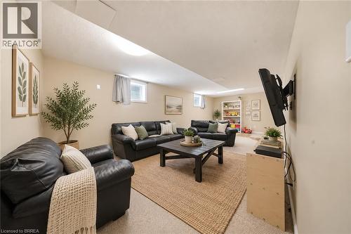 Finished lower level with neutral wall color, recessed lighting, and wall-to-wall carpeting - 61 Sunnyside Drive, St. George, ON 