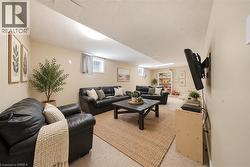 Finished lower level with neutral wall color, recessed lighting, and wall-to-wall carpeting - 