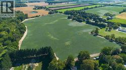 Expansive agricultural fields with surrounding wooded areas - 