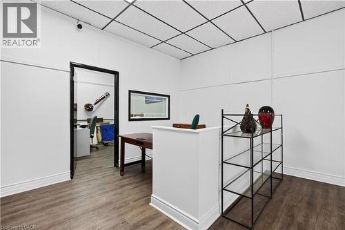 Hardwood-finish flooring, white walls, drop ceiling, and an open doorway - 689 E Barton Street E, Hamilton, ON 