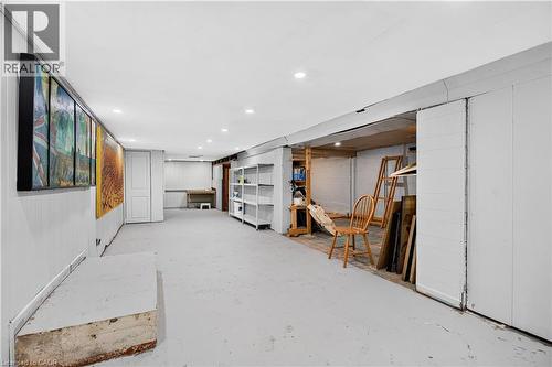 Spacious lower level featuring recessed lighting, paneled walls, and built-in shelving - 689 E Barton Street E, Hamilton, ON 