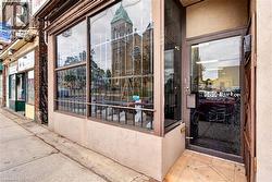 Commercial storefront with expansive display windows, street-level entrance, and tiled entry - 