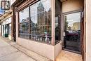 Commercial storefront with expansive display windows, street-level entrance, and tiled entry - 689 E Barton Street E, Hamilton, ON 