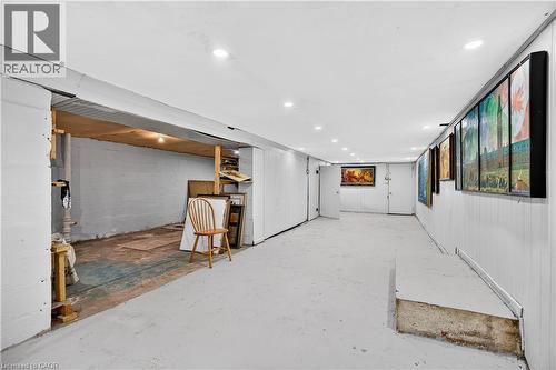 Spacious interior with painted concrete flooring, recessed lighting, and white paneled walls - 689 Barton Street E, Hamilton, ON 