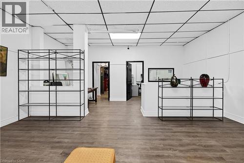 Wood-finish flooring, white walls, and a drop ceiling with integrated lighting - 689 E Barton Street E, Hamilton, ON 