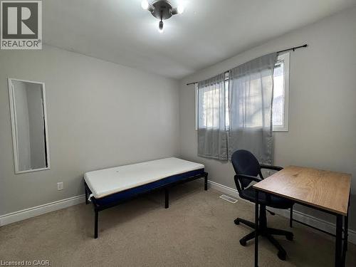 Carpeted flooring, neutral wall color, window with sheer curtains, and ceiling-mounted light fixture - 511 Havelock Drive, Waterloo, ON 