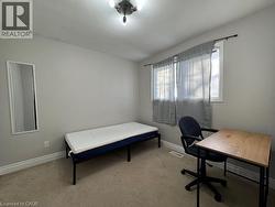 Carpeted flooring, neutral wall color, window with sheer curtains, and ceiling-mounted light fixture - 