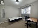 Carpeted flooring, neutral wall color, window with sheer curtains, and ceiling-mounted light fixture - 511 Havelock Drive, Waterloo, ON 