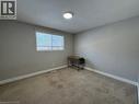 Recessed lighting fixture, light gray wall paint, window with white trim, light-colored carpeting - 511 Havelock Drive, Waterloo, ON 