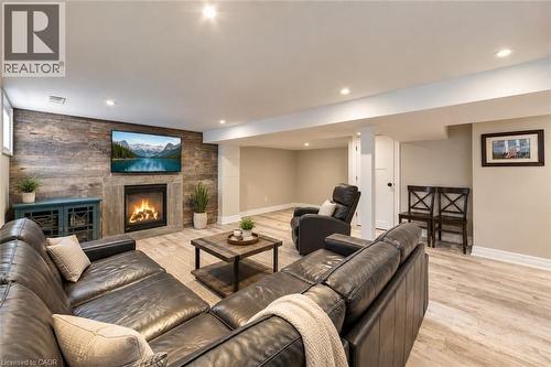Gas fireplace with barn board accent wall.  Storage closet. - 58 Uplands Avenue, Hamilton, ON 
