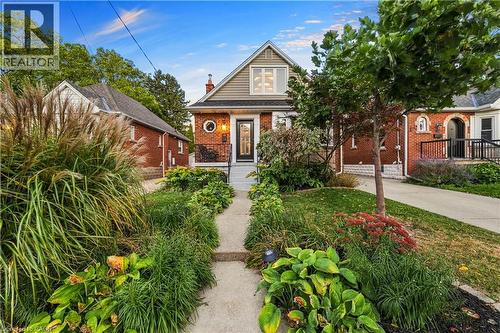 Brick exterior with siding accent. Low maintenance front garden with perennials. - 58 Uplands Avenue, Hamilton, ON 