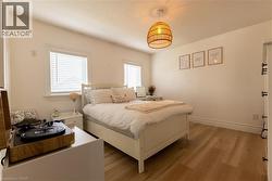 Recessed lighting, wood-finish flooring, and white window blinds - 
