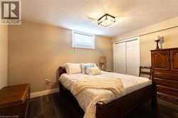 Recessed window with blinds, wood-finish flooring, and white bi-fold closet doors - 