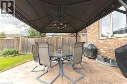 Stamped concrete patio featuring a gazebo with built-in lighting and a chandelier - 