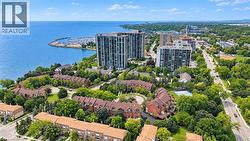 Waterfront property featuring a marina, residential buildings, and tree-lined streets - 