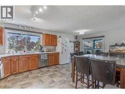 Large kitchen with lots of storage and counter space. Great light looking out to the backyard. Sliding door leading to the deck and the bonus room over the garage. - 