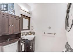 Lower-level powder room and laundry. - 
