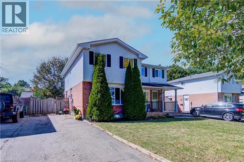 Two-story residence featuring light-toned siding and brick exterior - 39 Connelly Drive, Kitchener, ON 