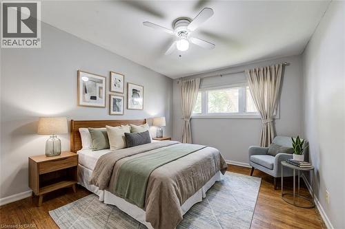 Hardwood flooring, painted walls, ceiling fan, window with curtains, and built-in lighting - 192 Warren Road, Kitchener, ON 