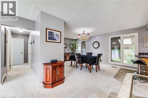 Recessed lighting and a chandelier illuminate the carpeted area - 192 Warren Road, Kitchener, ON 