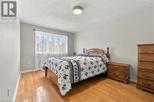 Hardwood flooring, painted walls, ceiling-mounted lighting, crown molding, and a window with a curtain rod - 5180 Oakley Drive, Burlington, ON 