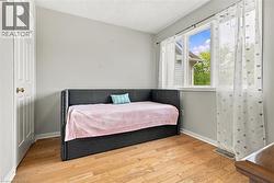 Wood-finish flooring with a multi-pane window and a classic paneled door - 