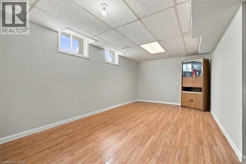 Recessed windows, wood-finish flooring, painted walls, drop ceiling, and overhead lighting - 5180 Oakley Drive, Burlington, ON 