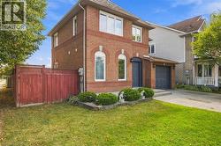 Brick exterior with a peaked roof, arched windows, and an attached garage - 