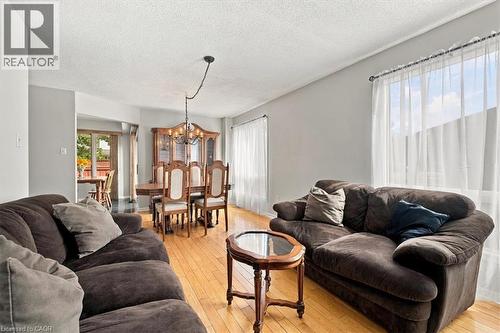 Hardwood flooring throughout, with a dedicated dining area featuring a chandelier - 5180 Oakley Drive, Burlington, ON 