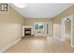 Open-concept living space featuring a corner fireplace with tile surround and mantle - 