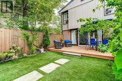 Surrounded by plants and flowers. - 