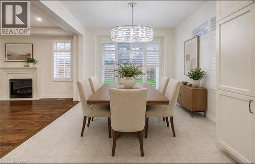 Kitchen featuring white cabinetry, granite-finish countertops, stainless steel appliances, and subway tile backsplash - 52 Pointer Street, Cambridge, ON 