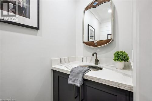 Vanity with dark cabinetry, white countertop, and an undermount basin - 1261 Stephenson Drive, Burlington, ON 