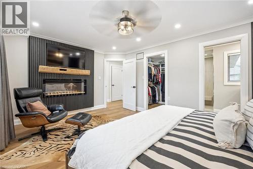 Recessed lighting, wood-finish flooring, built-in fireplace, ceiling fan with light fixture, and a built-in closet system - 1261 Stephenson Drive, Burlington, ON 