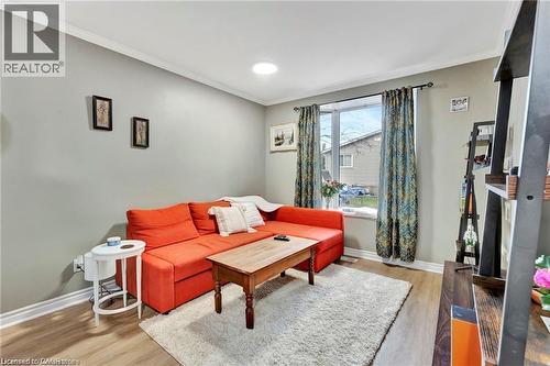 Wood-finish flooring with light-toned walls and white trim - 93 Robertson Crescent, Kitchener, ON 