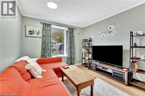 Recessed ceiling lighting, crown molding, wood-finish flooring, and built-in shelving - 93 Robertson Crescent, Kitchener, ON 