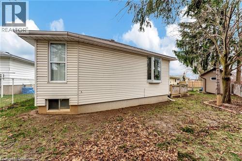 Vinyl siding exterior with a bay window, a lower level window, and a shed - 93 Robertson Crescent, Kitchener, ON 