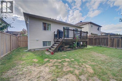 Rear exterior with a wood deck, wood privacy fencing, and a lower-level window - 317 Christopher Drive, Cambridge, ON 