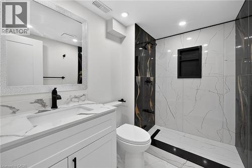 White vanity with an integrated sink and matte black faucet - 50 West 4Th Street, Hamilton, ON 