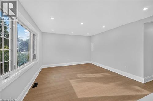 Recessed lighting, wood-finish flooring, crisp white trim, and a multi-pane window - 50 West 4Th Street, Hamilton, ON 