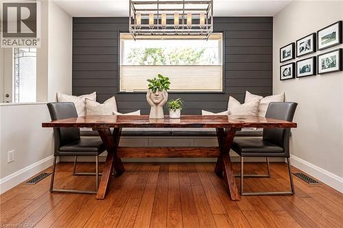 Hardwood flooring throughout, built-in window seating, and a modern chandelier - 896 Eagle Drive, Burlington, ON 